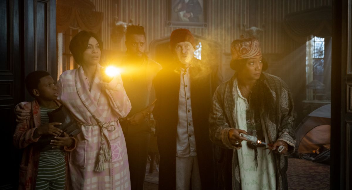 Chase Dillon as Travis, Rosario Dawson as Gabbie, LaKeith Stanfield as Ben, Owen Wilson as Father Kent, and Tiffany Haddish as Harriet in Disney's 'Haunted Mansion.'